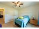 Bedroom featuring ceiling fan, wood-look floors and a window with natural light at 3642 Fantasy Way, Brooksville, FL 34604