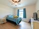Bright bedroom featuring ceiling fan, wood-look floors, and natural light at 3642 Fantasy Way, Brooksville, FL 34604