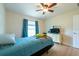 Bedroom featuring ceiling fan, wood-look floors, and window with natural light at 3642 Fantasy Way, Brooksville, FL 34604