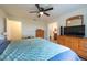 Spacious bedroom featuring a ceiling fan, wood-look floors, and natural light at 3642 Fantasy Way, Brooksville, FL 34604