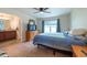 Bedroom with ensuite bathroom, ceiling fan, wood-look floors and natural light at 3642 Fantasy Way, Brooksville, FL 34604