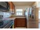 Bright kitchen featuring stainless steel refrigerator, range, and window with natural light at 3642 Fantasy Way, Brooksville, FL 34604