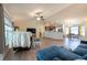 Cozy living area with wood floors that transition to a dinette and kitchen at 3642 Fantasy Way, Brooksville, FL 34604
