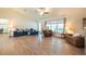Open concept living room features modern furnishings, wood floors and cathedral ceiling at 3642 Fantasy Way, Brooksville, FL 34604