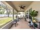 Covered patio with a ceiling fan, a grill, outdoor furniture, and potted plants at 3642 Fantasy Way, Brooksville, FL 34604