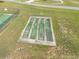 Aerial view of a shuffleboard court set on a green field with cut lanes, perfect for community fun and games at 3642 Fantasy Way, Brooksville, FL 34604