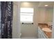 Bathroom featuring vanity with drawers, a shower with decorative curtain and a decorative window at 38535 Clinton Ave, Dade City, FL 33525