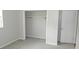 Bedroom featuring a neutral wall color and carpet, and an empty closet providing ample storage space at 38535 Clinton Ave, Dade City, FL 33525
