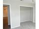 A bedroom featuring an empty closet providing ample storage and is located adjacent to a doorway at 38535 Clinton Ave, Dade City, FL 33525