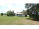 Single-Gathering home with a large, grassy yard and mature trees, creating a peaceful and private setting at 38535 Clinton Ave, Dade City, FL 33525