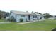 A single-story home with a stone facade, showcasing the front yard and exterior features at 38535 Clinton Ave, Dade City, FL 33525