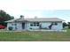 Charming single-story home featuring a stone facade, well-maintained lawn, and a welcoming front entrance at 38535 Clinton Ave, Dade City, FL 33525