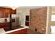 This kitchen features dark wood cabinets, stainless steel fridge and a brick accent wall at 38535 Clinton Ave, Dade City, FL 33525