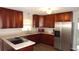 Well-equipped kitchen with wooden cabinetry, stainless steel appliances, and laminate countertops at 38535 Clinton Ave, Dade City, FL 33525
