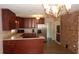 Well-lit kitchen featuring stainless steel refrigerator, dark wood cabinets, and an island with cooktop at 38535 Clinton Ave, Dade City, FL 33525