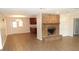 Inviting living room featuring a brick fireplace, tiled floors, and view of the kitchen at 38535 Clinton Ave, Dade City, FL 33525