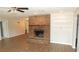 Living room showcasing a brick fireplace, built-in shelves, and tiled floors at 38535 Clinton Ave, Dade City, FL 33525