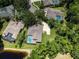 Aerial view of homes with screened pools backing to community lake at 3910 Saywood Ct, Palm Harbor, FL 34685