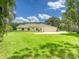 Expansive backyard features a well-maintained lawn and serene surroundings at 3910 Saywood Ct, Palm Harbor, FL 34685