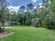 Sprawling backyard with mature trees providing shade and privacy at 3910 Saywood Ct, Palm Harbor, FL 34685