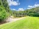Scenic backyard view features a tranquil pond and lush green lawn at 3910 Saywood Ct, Palm Harbor, FL 34685
