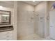 Elegant bathroom featuring a glass-enclosed shower, tiled walls, and modern fixtures at 3910 Saywood Ct, Palm Harbor, FL 34685