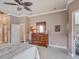 Bedroom featuring wood dresser, and access to lanai with views of the pool area at 3910 Saywood Ct, Palm Harbor, FL 34685