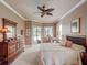 Serene bedroom with neutral decor, a ceiling fan, direct access to the lanai and view of the pool at 3910 Saywood Ct, Palm Harbor, FL 34685