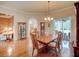 Dining room with hardwood floors, elegant chandelier, and lots of space for entertainment at 3910 Saywood Ct, Palm Harbor, FL 34685