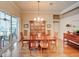 Formal dining room featuring hardwood floors, chandelier, and sliding glass doors at 3910 Saywood Ct, Palm Harbor, FL 34685