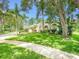 Beautiful home featuring lush landscaping, mature trees, and a well-manicured lawn at 3910 Saywood Ct, Palm Harbor, FL 34685