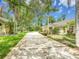 Charming home with a well-manicured lawn and inviting driveway at 3910 Saywood Ct, Palm Harbor, FL 34685