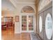 Inviting foyer with hardwood floors, double doors, and classic archways at 3910 Saywood Ct, Palm Harbor, FL 34685