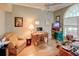 Comfortable home office with hardwood floors, chair, computer desk and natural light from a large arched window at 3910 Saywood Ct, Palm Harbor, FL 34685