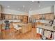 Spacious kitchen with wood floors, ample cabinetry, granite counters, stainless appliances, and center island with seating at 3910 Saywood Ct, Palm Harbor, FL 34685