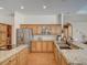 Bright kitchen featuring granite countertops, stainless steel appliances, white subway tile backsplash, and light wood cabinetry at 3910 Saywood Ct, Palm Harbor, FL 34685