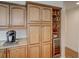 Custom kitchen cabinets with granite countertops and stainless wine cooler on display at 3910 Saywood Ct, Palm Harbor, FL 34685