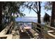 Breathtaking lake view from the wooden deck with a picnic table, perfect for enjoying the tranquil scenery at 3910 Saywood Ct, Palm Harbor, FL 34685