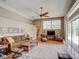 Comfortable living room with high ceilings, a ceiling fan, access to the pool area, and stylish furnishings at 3910 Saywood Ct, Palm Harbor, FL 34685
