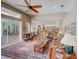 Spacious living room with hardwood floors, comfortable seating, access to the lanai, and an open floor plan at 3910 Saywood Ct, Palm Harbor, FL 34685