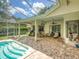 Spacious screened-in pool patio with ample seating for relaxing and entertaining at 3910 Saywood Ct, Palm Harbor, FL 34685