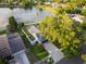 Aerial view of home by a lake showing the lot, paver driveway, mature trees, and fenced backyard at 3925 Dunaire Dr, Valrico, FL 33596