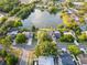 Beautiful aerial view of homes on a lakefront property with mature trees and lush green landscaping at 3925 Dunaire Dr, Valrico, FL 33596