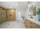 Spa-like bathroom with a standalone tub, glass-enclosed shower, and wooden vanity at 3925 Dunaire Dr, Valrico, FL 33596