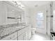 Bright bathroom features granite countertops, white cabinets, and a glass-enclosed shower at 3925 Dunaire Dr, Valrico, FL 33596