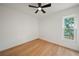 Relaxing bedroom has wood floors, a ceiling fan, and a window overlooking a lake at 3925 Dunaire Dr, Valrico, FL 33596