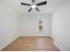 Clean bedroom features wood floors, white walls, and a ceiling fan at 3925 Dunaire Dr, Valrico, FL 33596