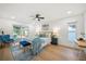 Bright bedroom with a ceiling fan, blue accents, and sliding glass doors to the pool at 3925 Dunaire Dr, Valrico, FL 33596