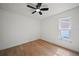 Clean bedroom features light wood floors, fresh white walls, and a window for natural light at 3925 Dunaire Dr, Valrico, FL 33596
