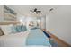 Spacious bedroom featuring a ceiling fan, wooden floors, and ensuite bathroom at 3925 Dunaire Dr, Valrico, FL 33596